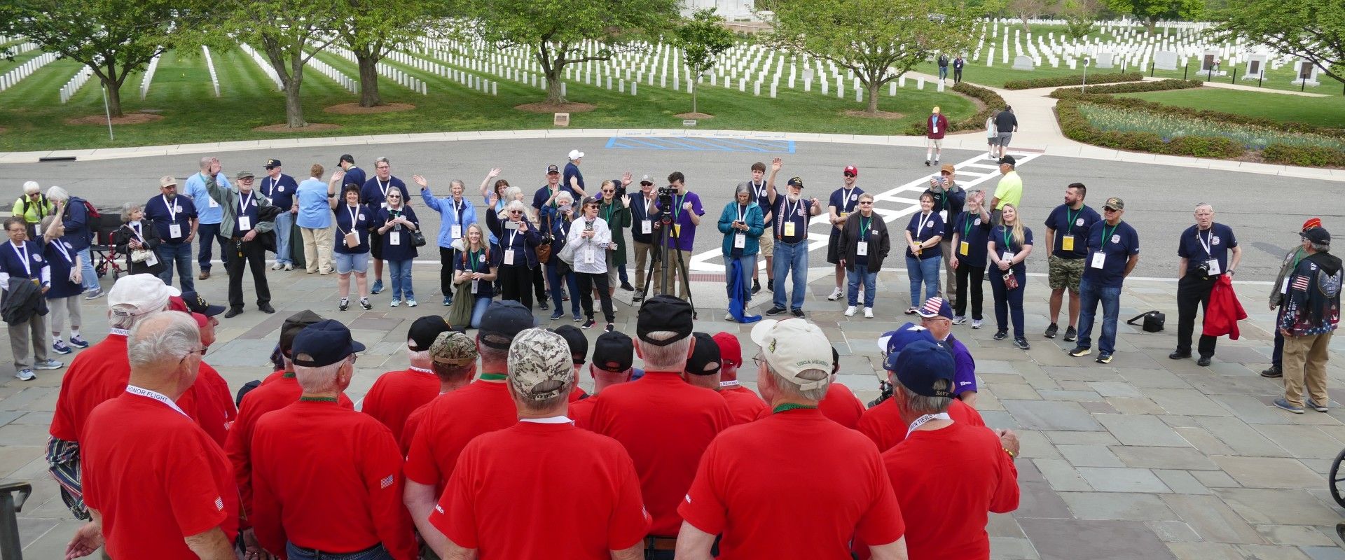 Veterans taking picture on steps outside of Arlington Cemetery, surrounded by Guardians and other staff.