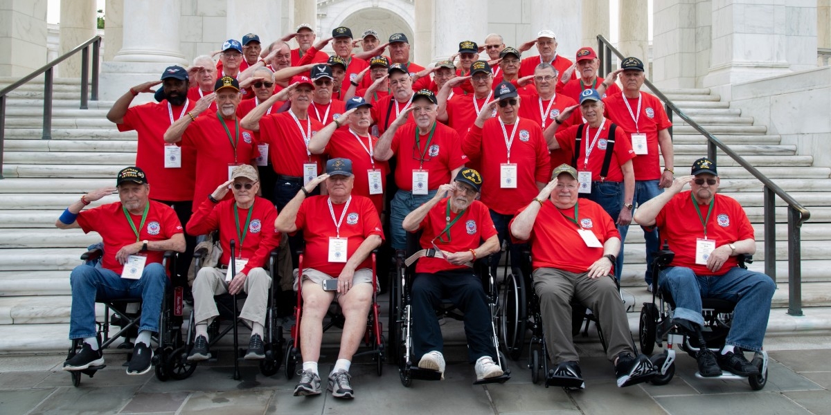 Veterans from Mission 17 Saluting to the camera at the stairs of Arlington National Cemetery